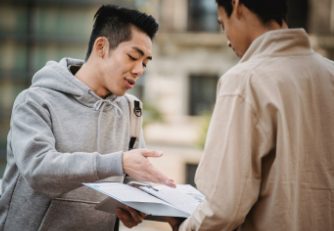 two people looking at a book